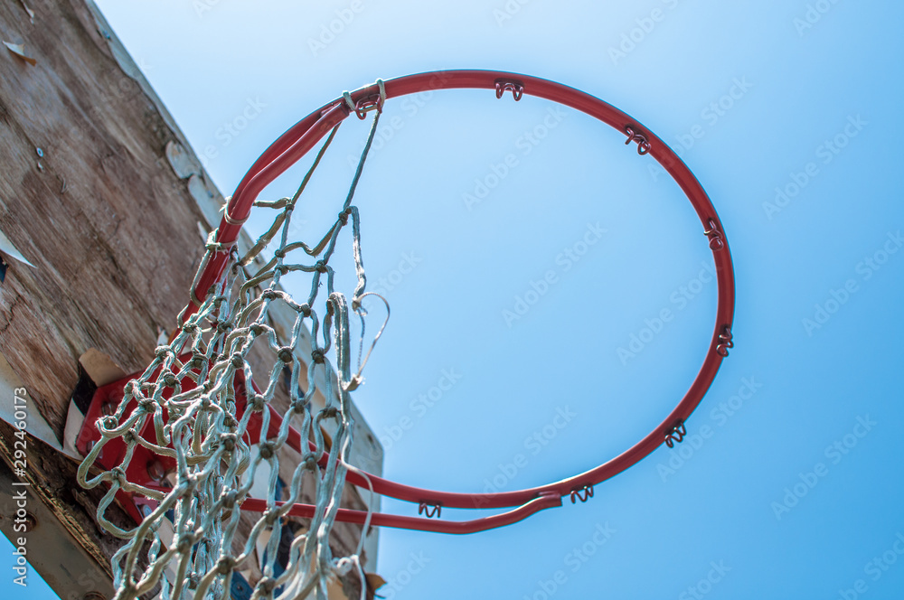 Old basketball hoop with torn net Old basketball hoop with torn net