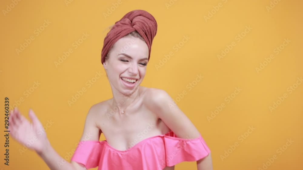 young girl with towel on her head over isolated orange background shows emotions young girl with towel on her head over isolated orange background shows emotions