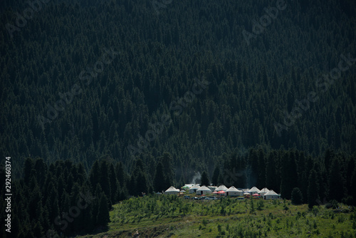 Yurt nomadic houses camp at mountain valley in Central Asia photo