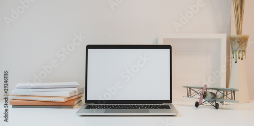 Open blank screen laptop with coffee cup and office supplies in minimal workplace © bongkarn