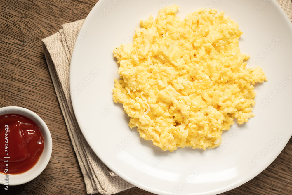Scramble on a white plate with copy space,ketchup bowl Scramble on a white plate with copy space,ketchup bowl