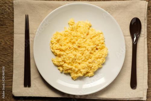 Scramble on a white plate with spoon and chopsticks,copy space