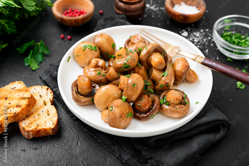 Fried mushrooms with fresh herbs in white plate. Fried mushrooms with fresh herbs in white plate.