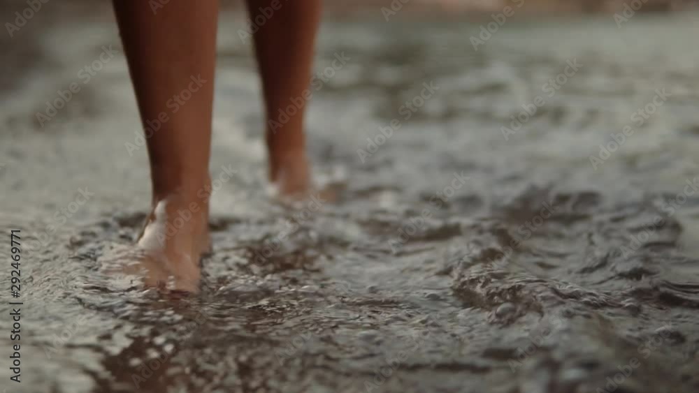 Woman Walks On Sands Beach In Slow Motion And Waves Breaking About Feet.Beautiful Female Feet Walking On Seashore With Splashing Waves.Feet Young Woman Walking On Beach In Summer Vacation Or Holiday. Woman Walks On Sands Beach In Slow Motion And Waves Breaking About Feet.Beautiful Female Feet Walking On Seashore With Splashing Waves.Feet Young Woman Walking On Beach In Summer Vacation Or Holiday.