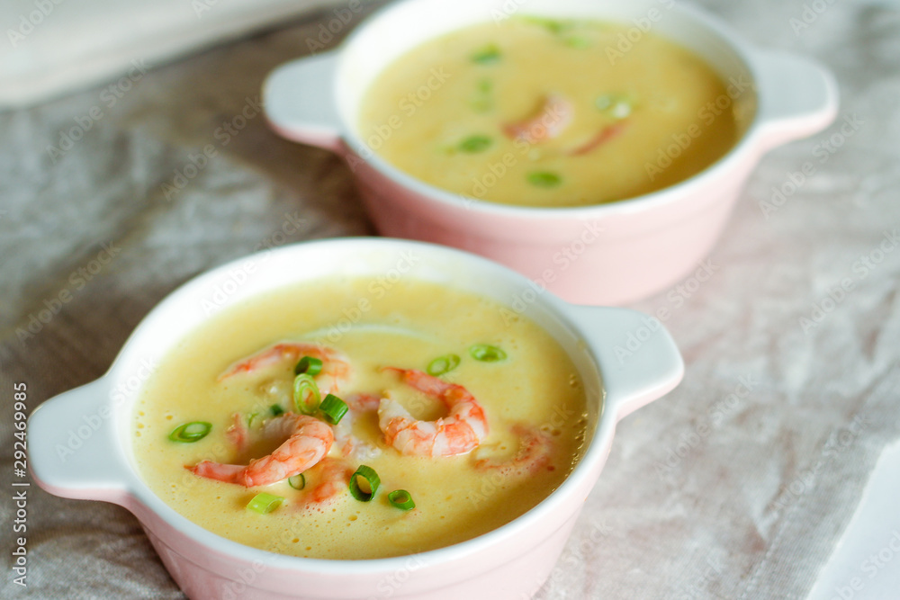 Tasty cream soup with fresh shrimps on table