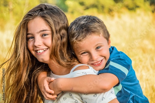 Brother hugging sister doing piggyback