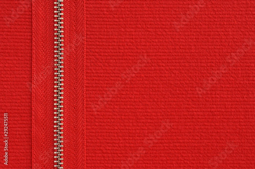 Red jersey fabric texture background with metal decorative zipper . Copy space