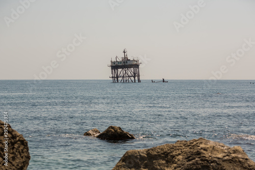 Abandoned oceanographic platform near Black Sea coast, Crimea. Old abandoned sea rusty drilling platform.