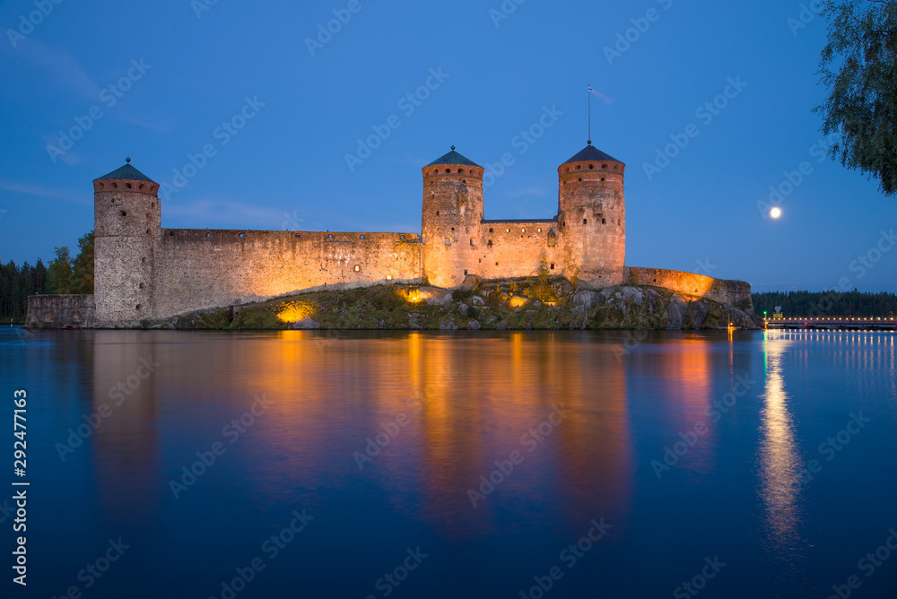 View of the ancient Olavinlinna fortress on a white July night. Savonlinna, Finland