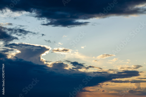 Torn cloud at sunset with shadows. Backlit by the bright yellow sun © Сергей Михайлов