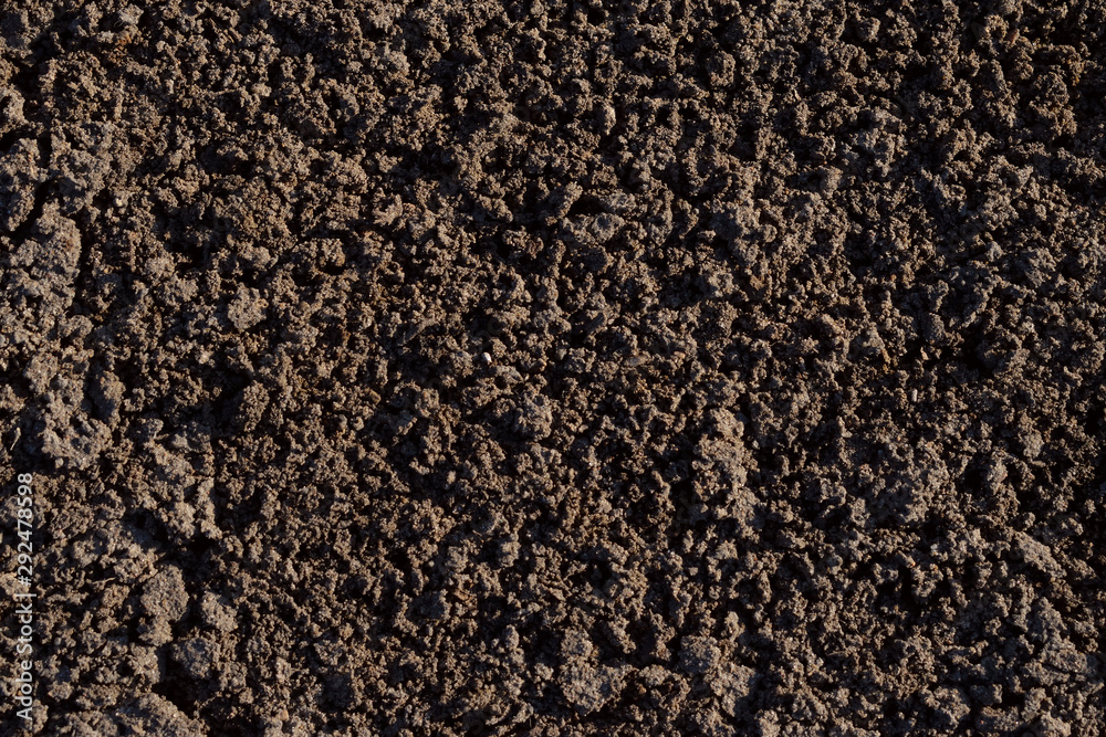 Soil background. Dark brown ground texture. Top view Soil background. Dark brown ground texture. Top view