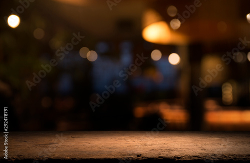 Obraz na plátně Empty wood table top on blur light gold bokeh of cafe restaurant in dark backgro