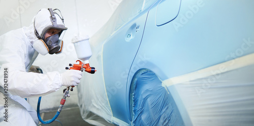 automobile painting. car painter with gun in chamber