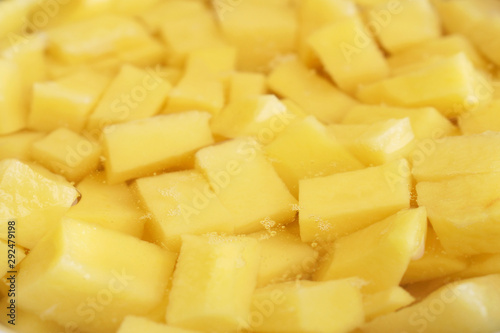 Sliced peeled raw potato in the water. Side view. Selective focus. Food background 