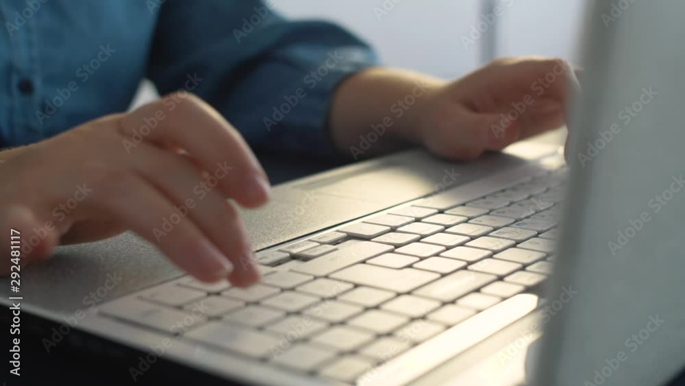 Close up of woman hand typing on laptop keyboard. Slow motion of business work uses laptop. Shopping online and use social network.