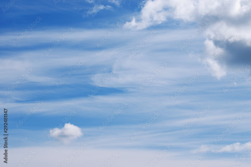 Beautiful white feathery and cumulus clouds in the blue sky. Picturesque cloudscape background. Copy space Beautiful white feathery and cumulus clouds in the blue sky. Picturesque cloudscape background. Copy space