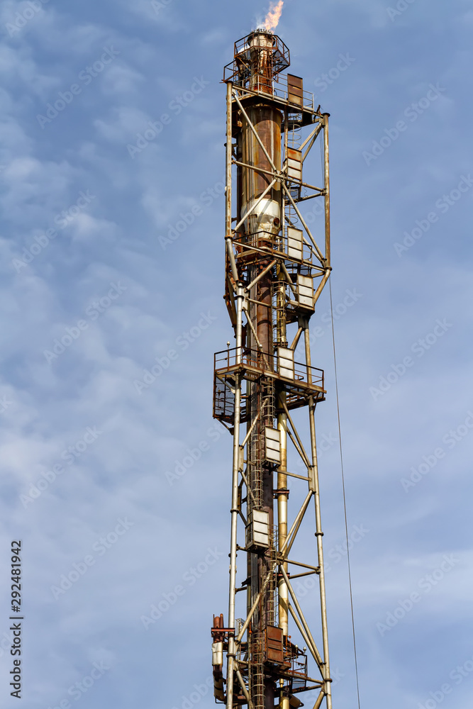 The old torch of the refinery after-burning waste products of heavy gases The old torch of the refinery after-burning waste products of heavy gases