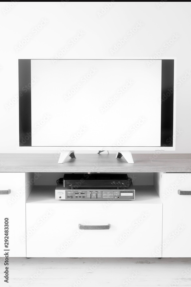 TV with white screen on a stand in the room. TV with white screen on a stand in the room.