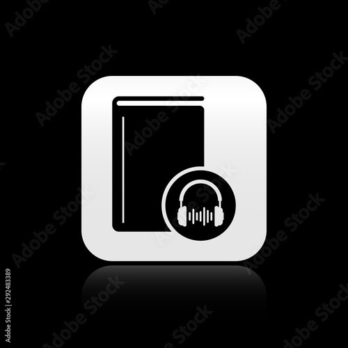 Black Audio book icon isolated on black background. Book with headphones. Audio guide sign. Online learning concept. Silver square button. Vector Illustration