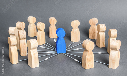 The blue person is connected with employees by wide network of lines. At the center of a complex large system. Communication social. Cooperation, collaboration. Project leadership personnel management photo