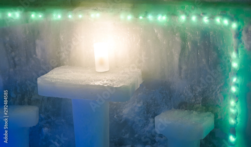 Bild auf Leinwand a table with two chairs and a light made of ice
