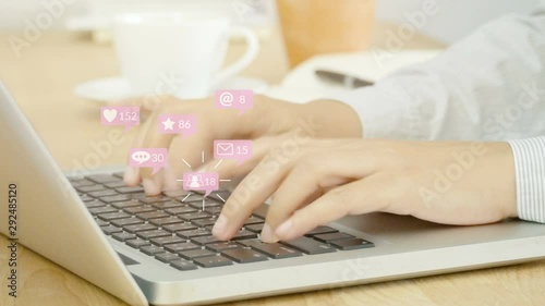 4K. people using notebook computer laptop for social media interactions with pop up of notification icons from friend in social network with like, message, email, mention and star above keyboard