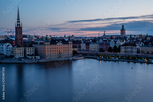 A colorful sunrise over Stockholm with the lights reflecting on the calm water of the sea - 6