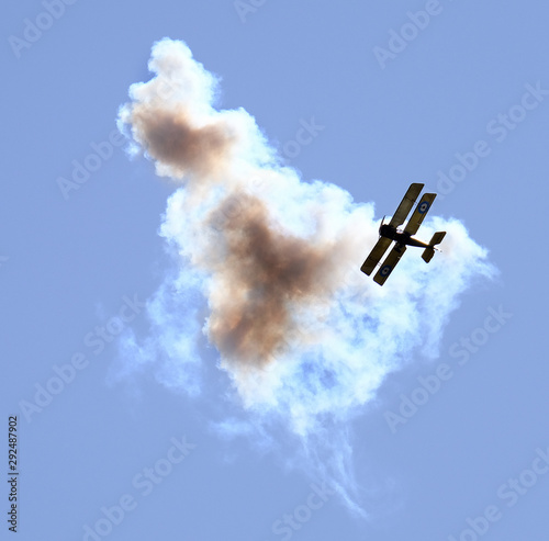 Replica first world war aircraft at air show under attack from anti aircraft fire. photo