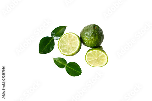 The kaffir lime is cut in half and paired with the leaves on a white background. clipping  path