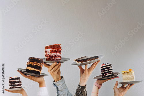 Cuadro en lienzo Concept for cafe or bakery with desserts: plates with different cakes in people'