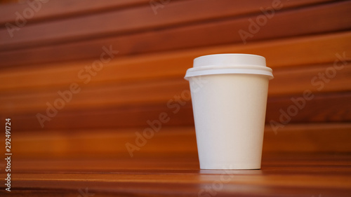 white paper cup on wooden background