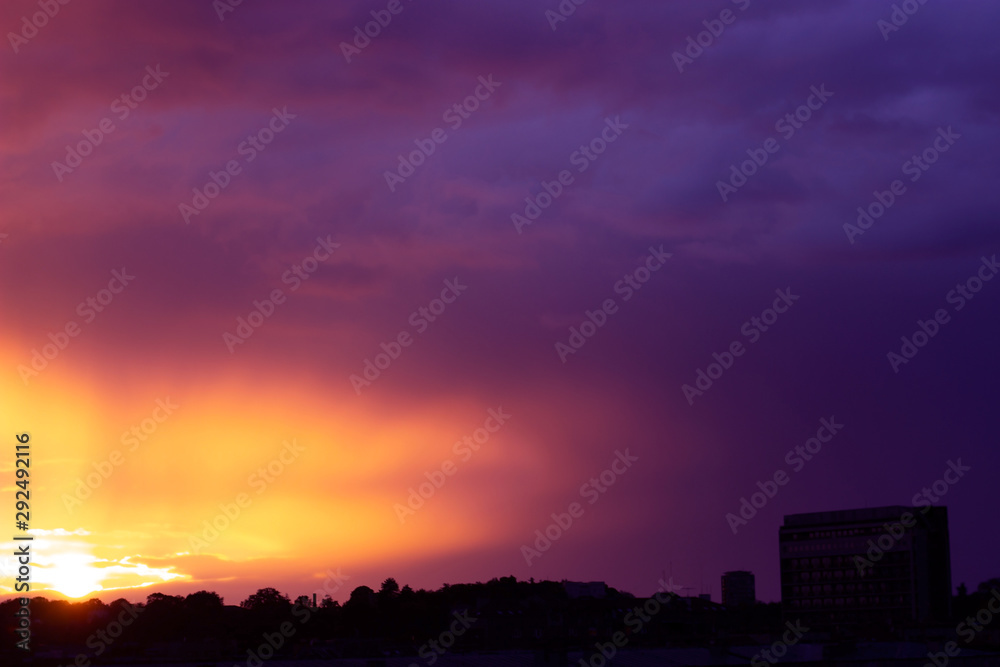 Beautiful pink and orange sunset over the city; nature background