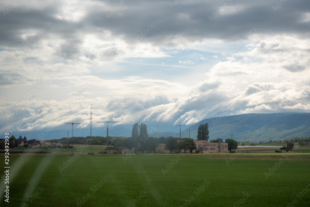 Beautiful scene of meadow in rural area of switzerland on cloud sky with sunlight background and copy space Beautiful scene of meadow in rural area of switzerland on cloud sky with sunlight background and copy space