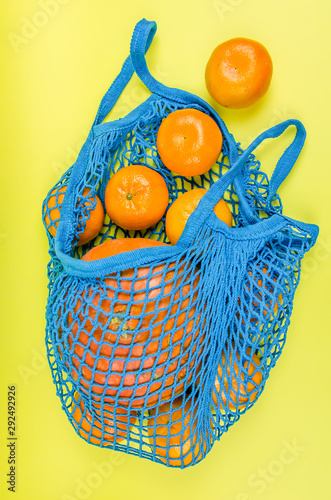 no plastic. oranges in a blue mesh bag