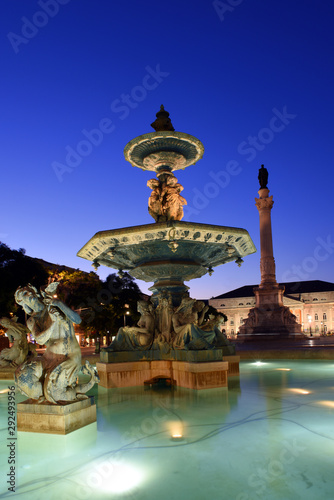 night view of the bronze fountains at Praca Dom Pedro IV, Rossio square in Lisbon, Portugal