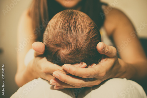 Newborn baby boy in his mother's hands photo