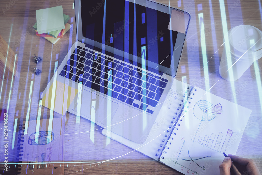 Fototapeta premium Double exposure of man's hands writing notes of stock market with forex chart.
