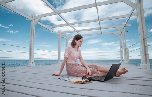 girl with laptop on the beach