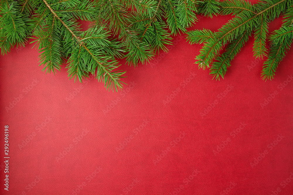 Border made of christmas pine tree over red background