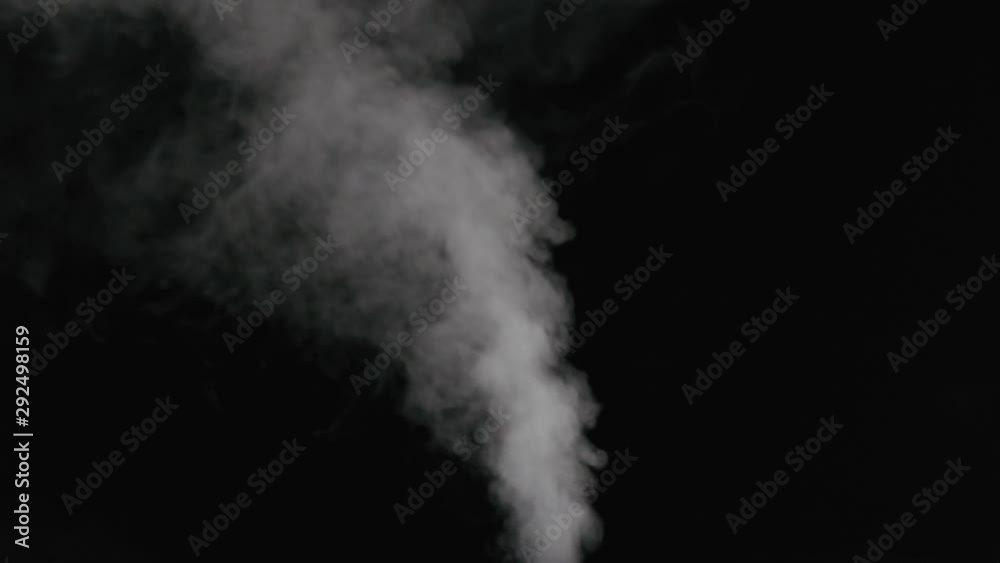 Slow motion water mist stream with wind effect over black background Slow motion water mist stream with wind effect over black background