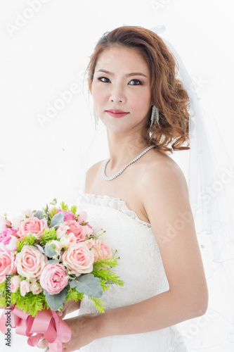 Bride is stands in beautiful white wedding dress..