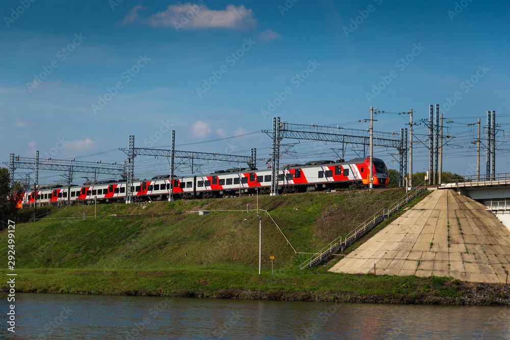 Russian modern high-speed electric train on a bridge. Sunny day.