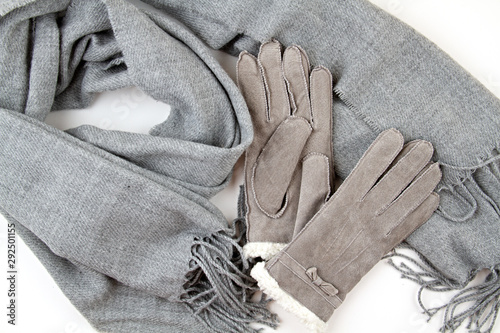 Flat lay composition with grey winter gloves and a warm woolen scarf