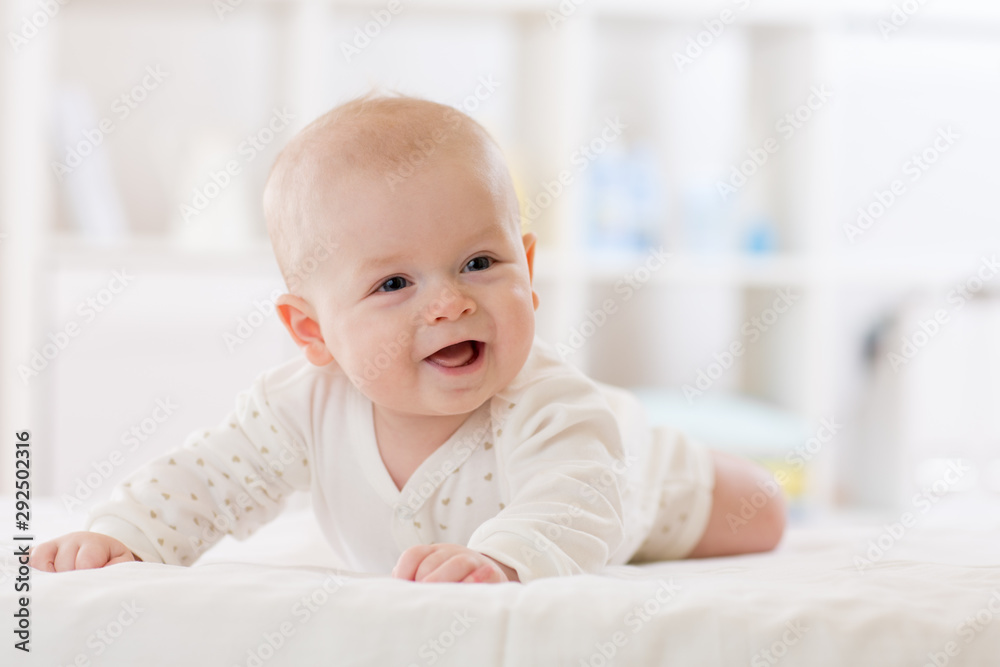 infant baby five months age lying on belly in nursery infant baby five months age lying on belly in nursery