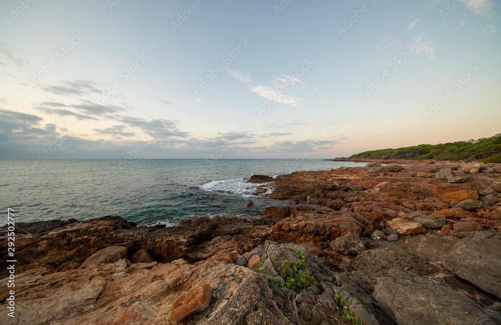Sunrise between rocks and the Oropesa Sea