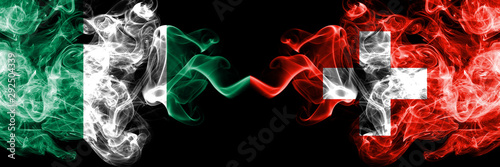 Nigeria vs Switzerland, Swiss abstract smoky mystic flags placed side by side. Thick colored silky smoke flags of Nigerian and Switzerland, Swiss