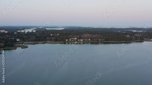 Aerial, drone shot,buildings on the coast of Soukansalmi, at dusk, on a sunny, autumn evening, in Espoo, Uusimaa, Finland
 photo