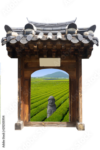 Open door on Jeju! Come visit. Traditional Seoul palace door open on green tea field of Jeju, with volcano. Dol hareubang Jeju Island sculpture.  Geyongbokgung and hanok style door from South Korea photo
