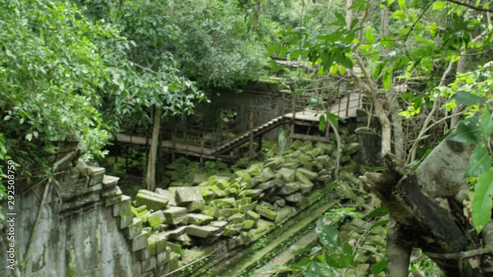 Ancient Temple Ruins in Cambodia.  Piles of Collapsed Rocks with Green Moss