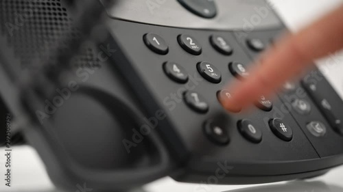 Male hand dialing telephone number